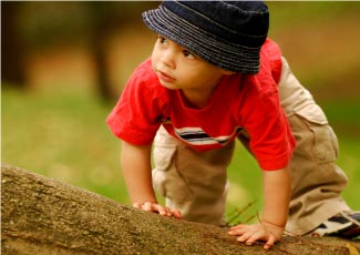 A toddler climbing a play structure