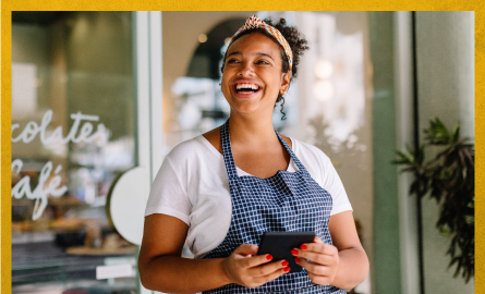 Image of a person working in a business, laughing 