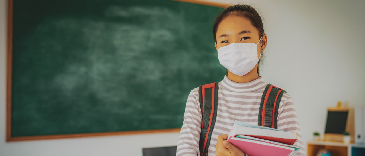 A girl wearing mask in school