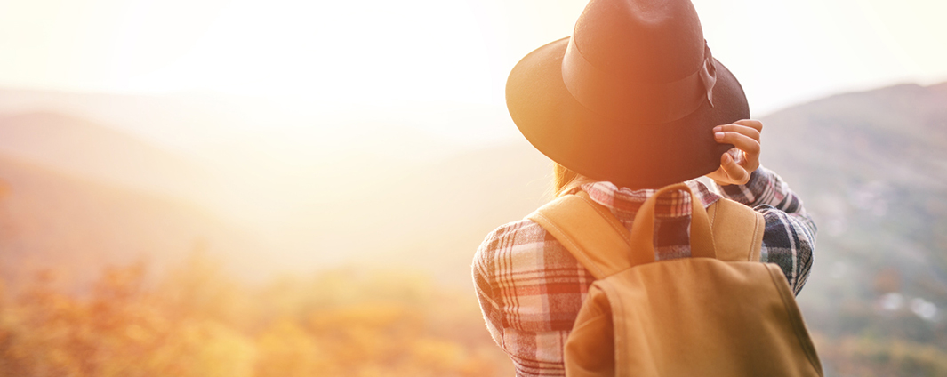 A woman looks at a sunset