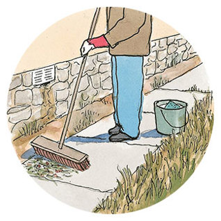 Person sweeping up debris around the outside of the house